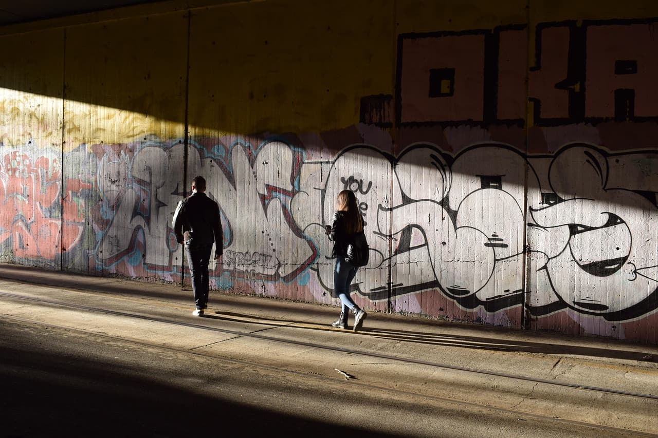 A dark tunnel opening onto a bright circle of light.